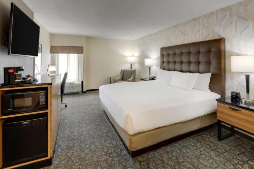 伯明翰Drury Inn & Suites Birmingham Lakeshore Drive的酒店客房设有一张大床和一台电视。