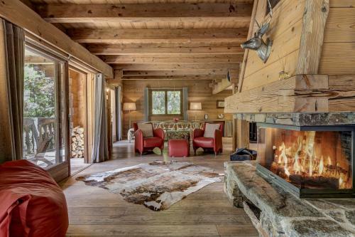 夏蒙尼-勃朗峰Chalet les Sauberands的带壁炉的客厅(位于木屋内)