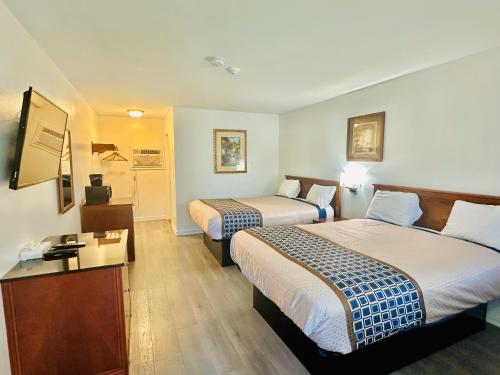 汉普顿Hampton Motor Inn的酒店客房配有两张床和一张书桌