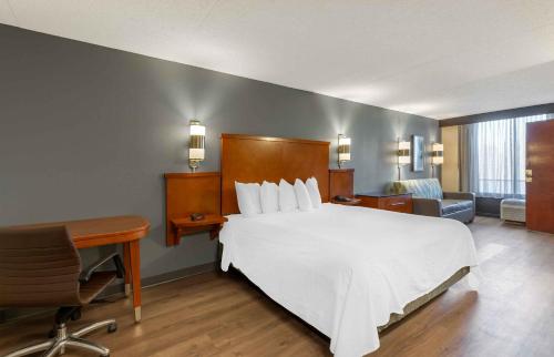 独立市Extended Stay America Premier Suites - Cleveland - Independence的卧室配有一张白色大床和一张书桌