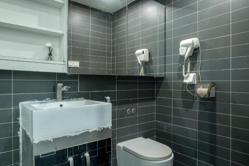 广州诺盟国际公寓广州先烈南路时代国际YOU店的一间带水槽、卫生间和镜子的浴室