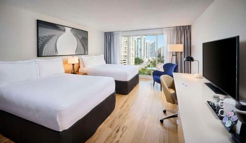 多伦多Radisson Blu Toronto Downtown的酒店客房设有两张床和一台平面电视。