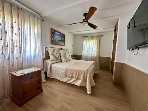 博罗尼亚House Beach的一间卧室配有一张床和吊扇