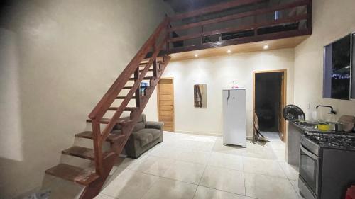帕林廷斯Casa para o Festival de Parintins的客厅设有木制楼梯和冰箱。