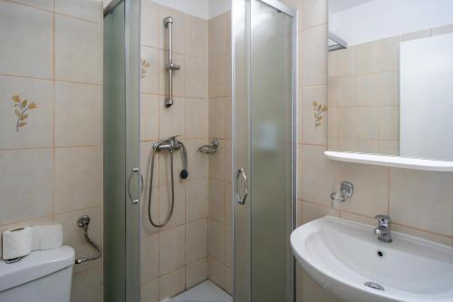 布加勒斯特布加勒斯特城市酒店的带淋浴和盥洗盆的浴室