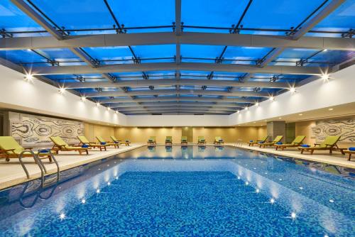 上海上海大宁福朋喜来登酒店的一个带椅子的室内游泳池和游泳池