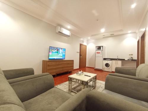 利雅德الماسم للأجنحة المخدومة- الملك فهد的客厅配有两张沙发和一台电视机