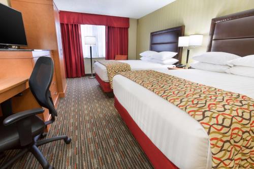 圣路易斯Drury Inn and Suites St Louis Union Station的酒店客房配有两张床和一张书桌