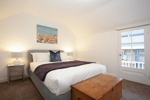 悉尼Spacious 3-Bed Family House with Courtyard的一间卧室设有一张大床和一个窗户。