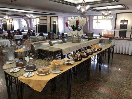 伊瓜苏伯多禄宫酒店的一个大宴会厅,配有餐桌,