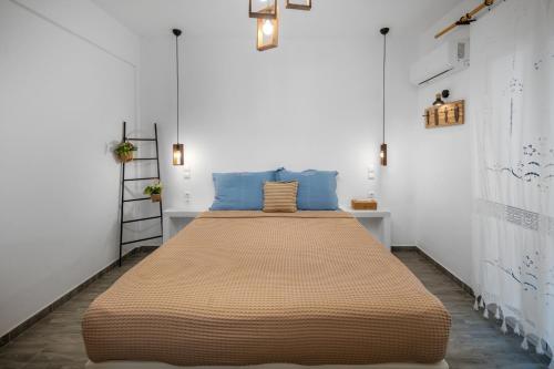 LivadakiaDorkas Luxury Rooms&Apartments的一间卧室配有一张带蓝色枕头的大床