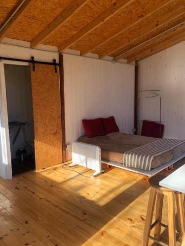蒂格雷la casa en el rio的铺有木地板的客房内设有一间卧室和一张床。
