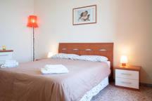 特雷维尼亚诺罗马诺Waterfront Casa Vacanze的一间卧室配有一张大床和一盏灯