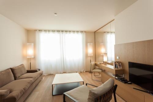 卢森堡纪尧姆套房公寓的带沙发和大窗户的客厅