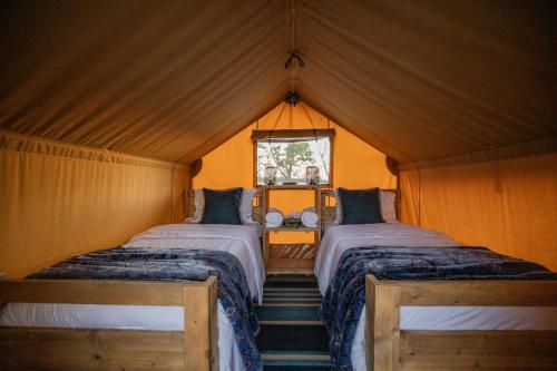 CassvilleRoaring River Luxury Adventure Tent #15的帐篷内带两张床的房间