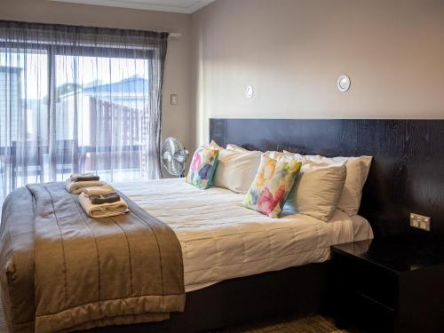 格雷默斯帕罗阿酒店的一间卧室设有一张大床和大窗户