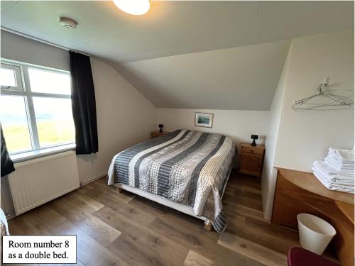 Grímsey博萨旅馆的一间卧室设有一张床和一个窗口
