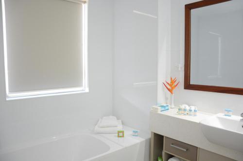 南迪拉笋纳迪机场公寓酒店的白色的浴室设有水槽和镜子