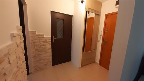 克拉科夫Apartament的走廊设有两扇门,铺有瓷砖地板
