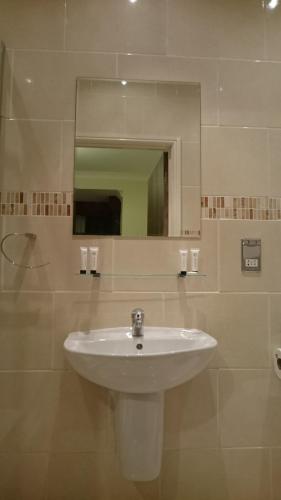 纽波特盖特威快捷酒店的浴室设有白色水槽和镜子
