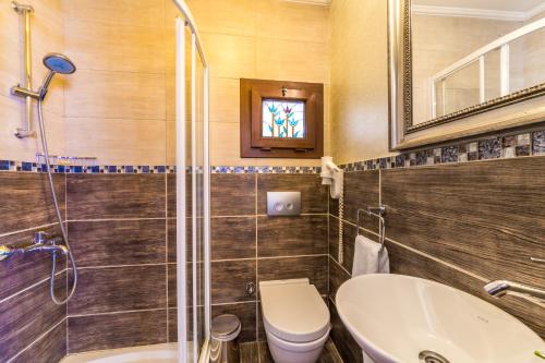 塞利米耶Badem Tatil Evi的一间带卫生间、水槽和镜子的浴室