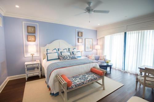 查尔斯顿查尔斯顿港海滩俱乐部度假村的一间卧室配有一张带蓝色墙壁的大床