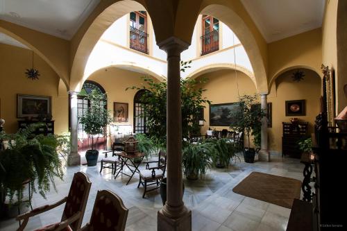 帕尔马德尔里奥Casa San José的建筑里带椅子和植物的房间