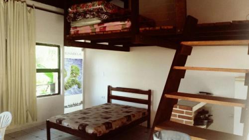 伊利亚贝拉Chalé do Saulo的一间卧室配有一张双层床,楼梯配有一张小床