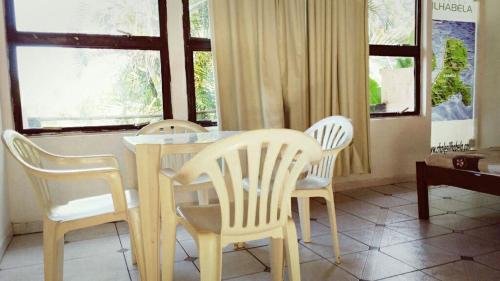 伊利亚贝拉Chalé do Saulo的一间带桌子和四把椅子的用餐室