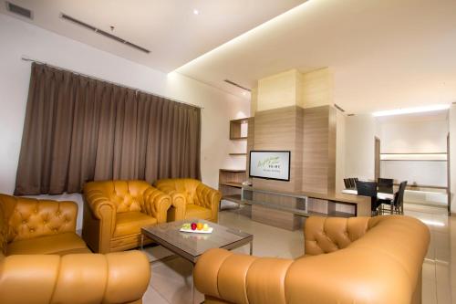 雅加达卡拉巴加丁薇姿普瑞酒店的客厅配有黄色家具和电视