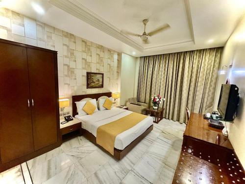 新德里GTB Florence Inn, 2min walk from Karol Bagh Metro的酒店客房,配有床和电视