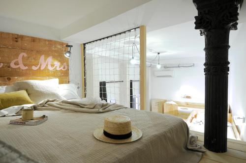 马德里马德里海特酒店的一间卧室,配有一张床,上面有帽子