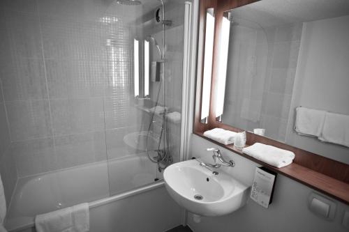 阿列河畔美岸钟楼威驰贝勒里弗酒店的一间带水槽、镜子和淋浴的浴室