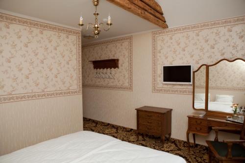 Rõuge奥比库洛别墅的一间卧室配有床、镜子和梳妆台