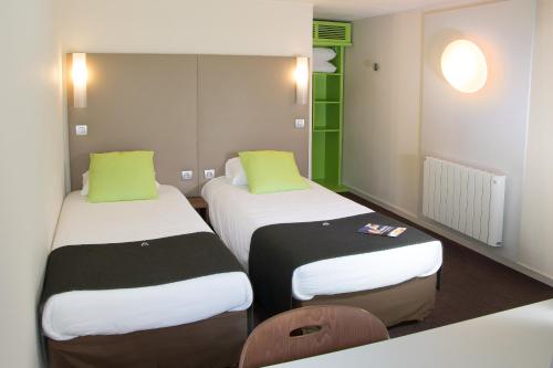 卢瓦尔河畔圣塞巴斯蒂安南特圣 - 塞巴斯蒂安 - 卢瓦尔河畔钟楼酒店的绿白色客房内的两张床