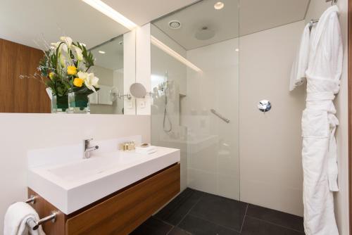 日内瓦日内瓦辉盛阁国际公寓的浴室配有白色水槽和淋浴。