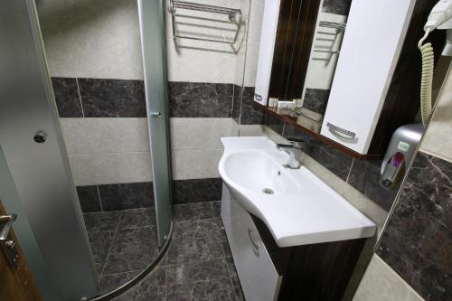 阿菲永Afyon Grand Ari Hotel的一间带水槽和镜子的浴室