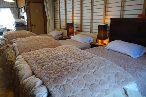 佐渡市Natural Mind Tour guest house - Vacation STAY 22268v的酒店客房的一组床位