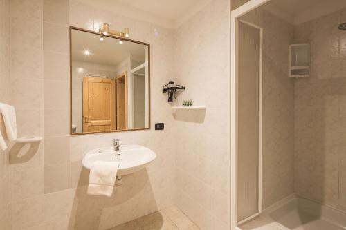 塔弗伊Stelvio Residence的白色的浴室设有水槽和淋浴。