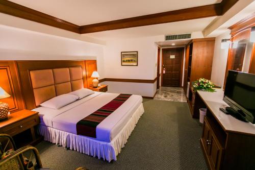 呵叻拉亚大酒店的酒店客房,配有床和电视