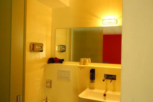 弗坦Hotel Bellavista Ftan的一间带镜子和水槽的浴室
