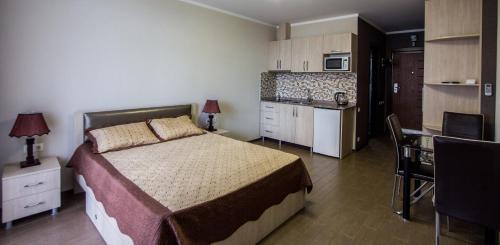 巴统My Batumi Apartments的一间带大床的卧室和一间厨房
