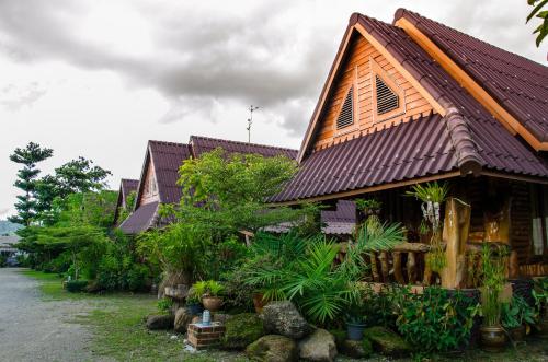 拉廊达兰伊度假旅馆的一座木屋顶的房子,一些植物