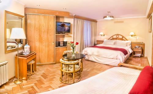 圣卡洛斯-德巴里洛切克里斯托酒店的酒店客房配有一张床铺和一张桌子。