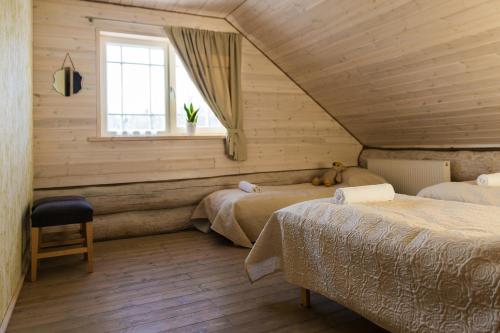 KohilaHumala Holiday Home的一间卧室设有两张床和窗户。