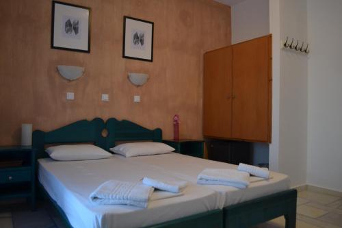 ManganariVenus Rooms的一间卧室配有一张床,上面有两条毛巾