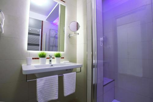 托雷桑塔萨宾娜Hotel Cicò的白色的浴室设有水槽和淋浴。