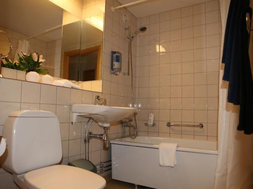 默恩达尔莫达兹兄弟酒店的浴室配有白色卫生间和盥洗盆。