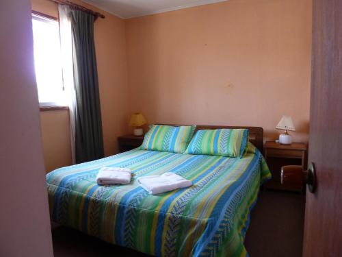 科金博卡瓦尼亚斯拉格兰德瑞纳斯公寓式酒店的一间卧室配有一张床,上面有两条毛巾