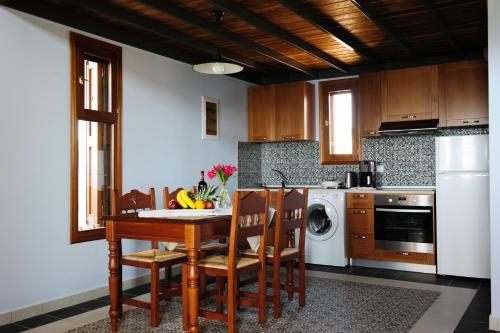 吉奥塔略阿里萨尼海滨别墅的厨房配有桌椅和洗碗机。